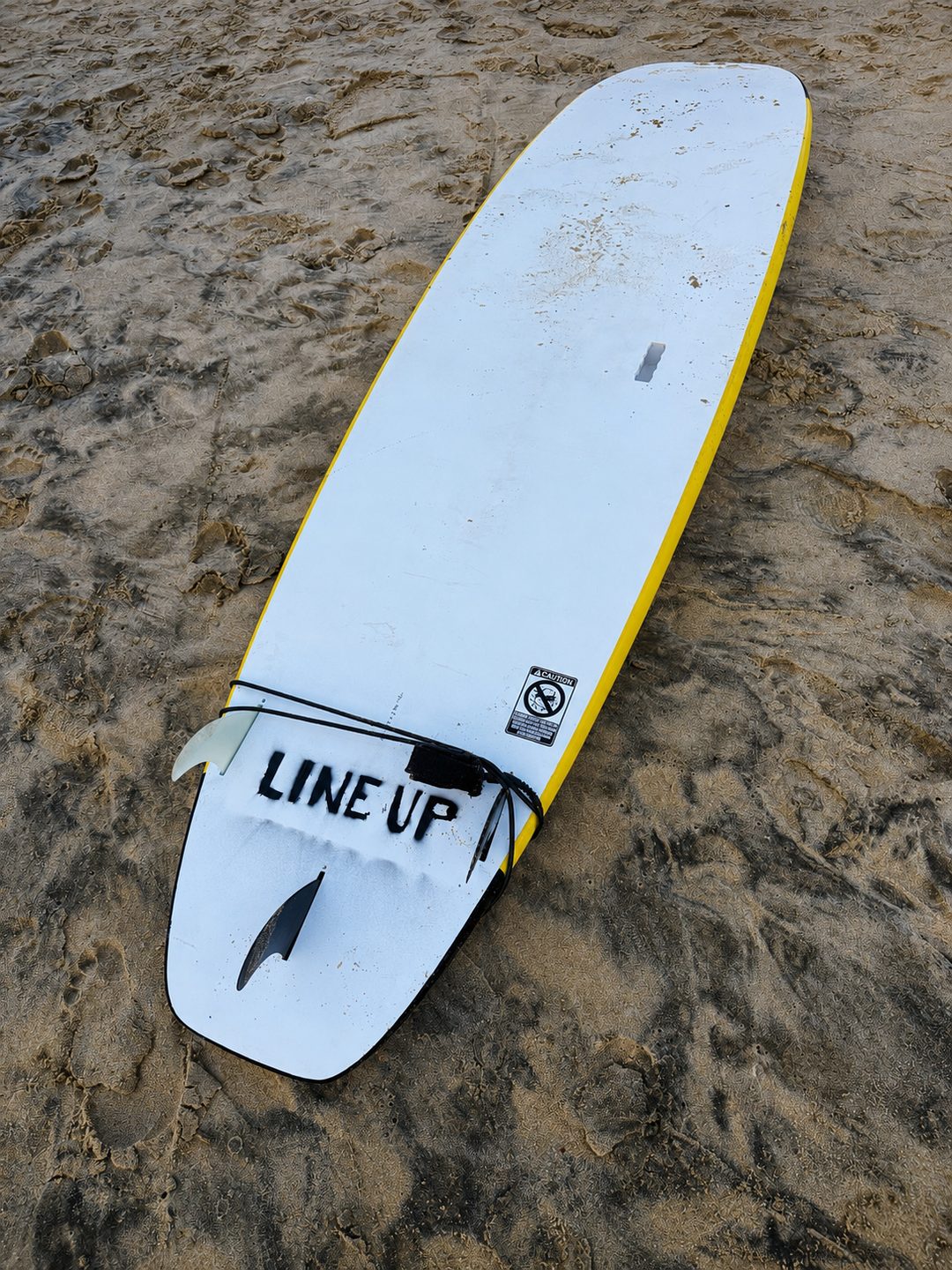 A longboard resting on the sand at Arugam Bay