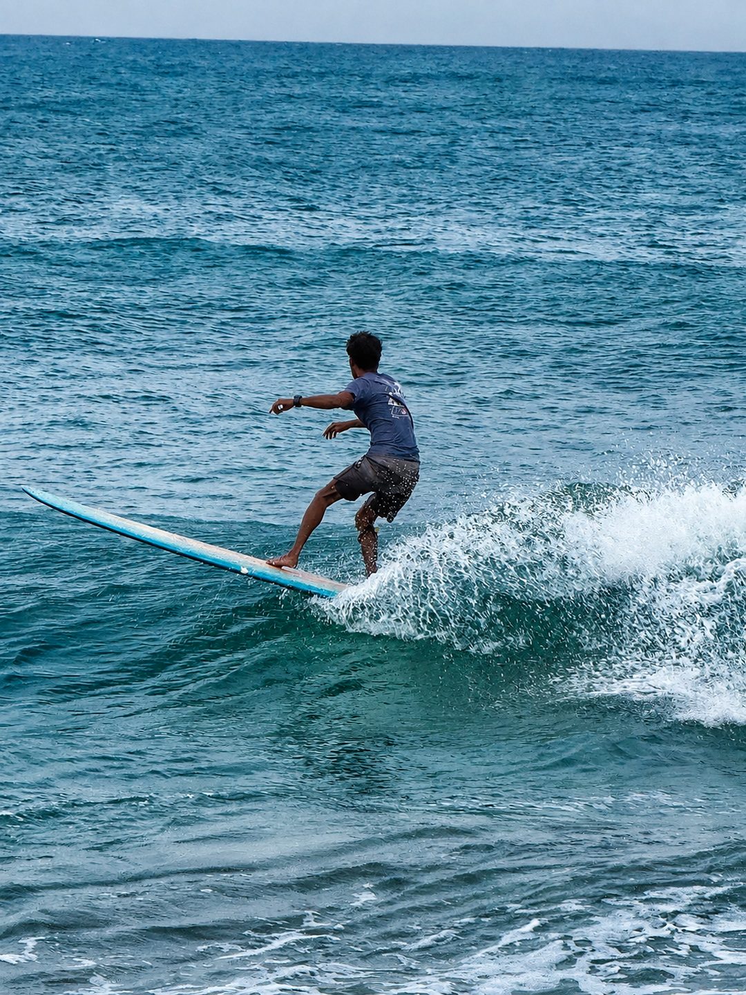 A surfer riding a right-hand wave at Arugam Bay